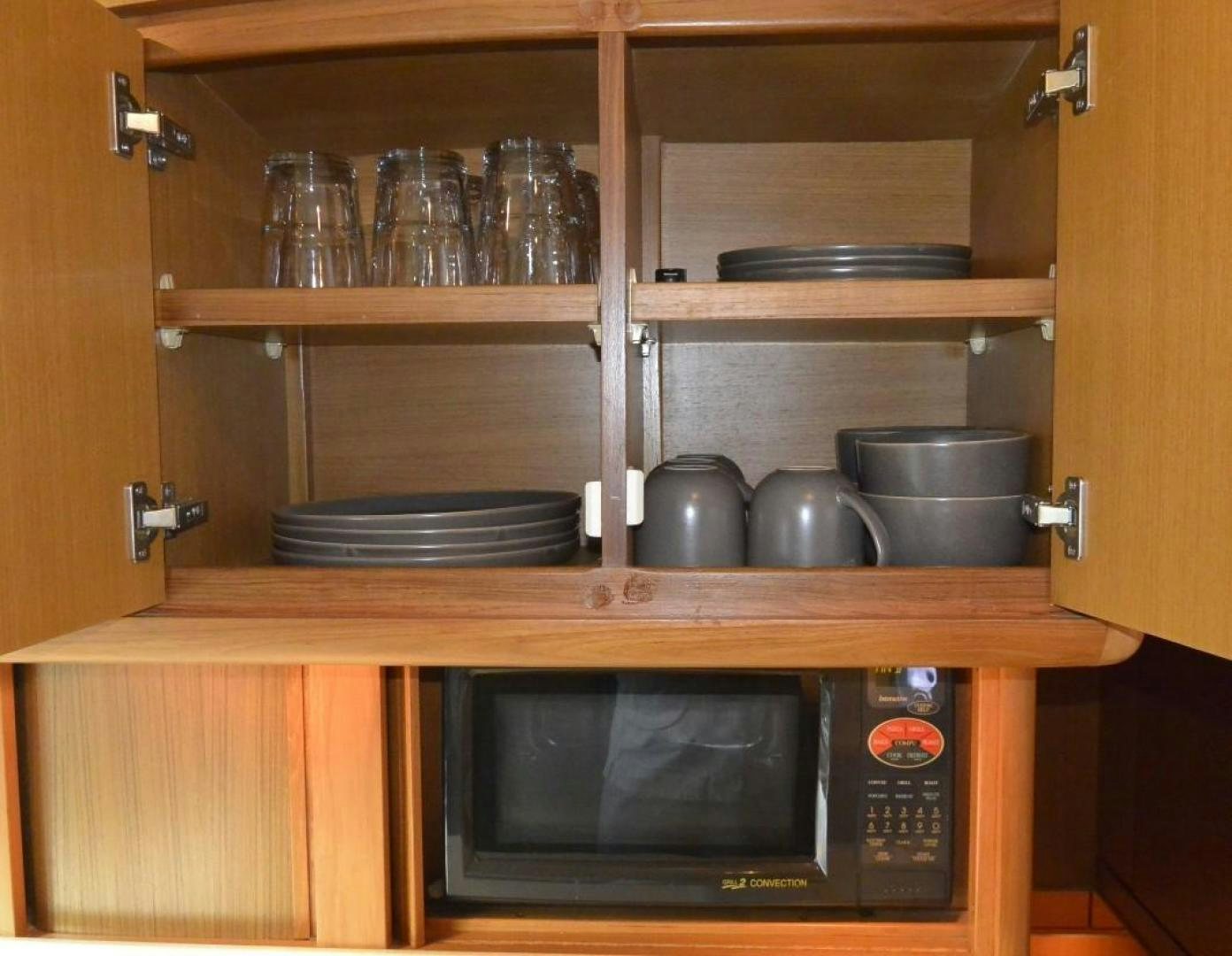 a microwave oven on a wooden shelf aboard DOG HOUSE Yacht for Sale
