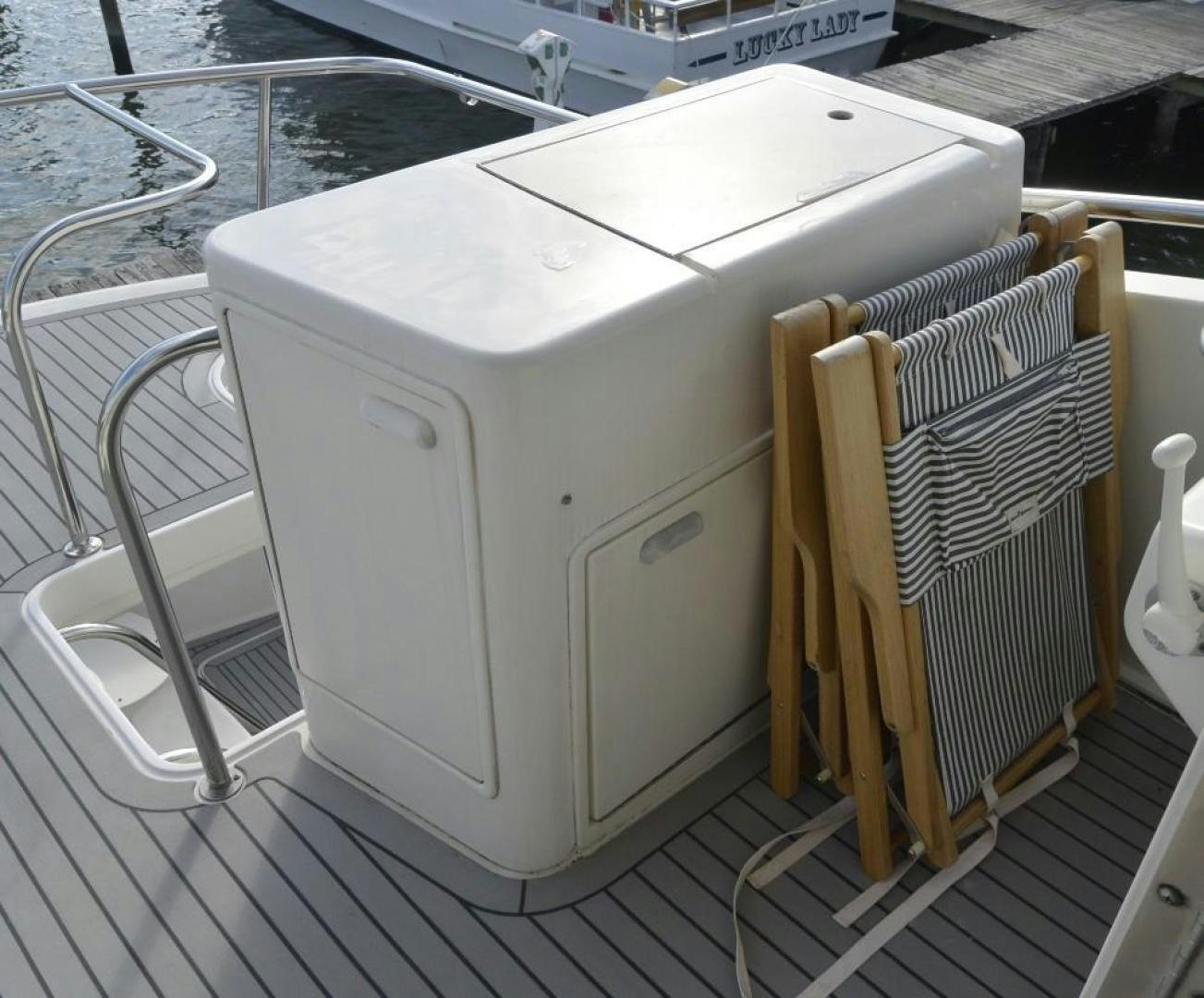 a white rectangular object with a wire on a wooden surface aboard DOG HOUSE Yacht for Sale