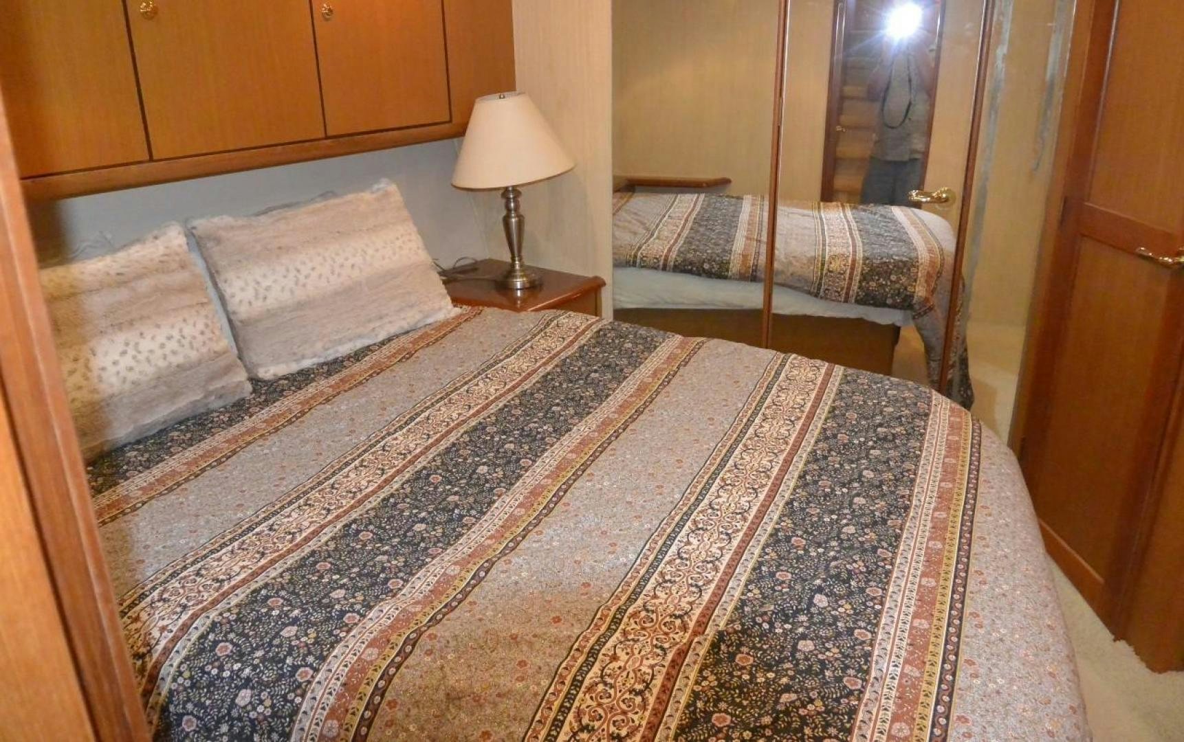 a bed with a lamp on it aboard DOG HOUSE Yacht for Sale