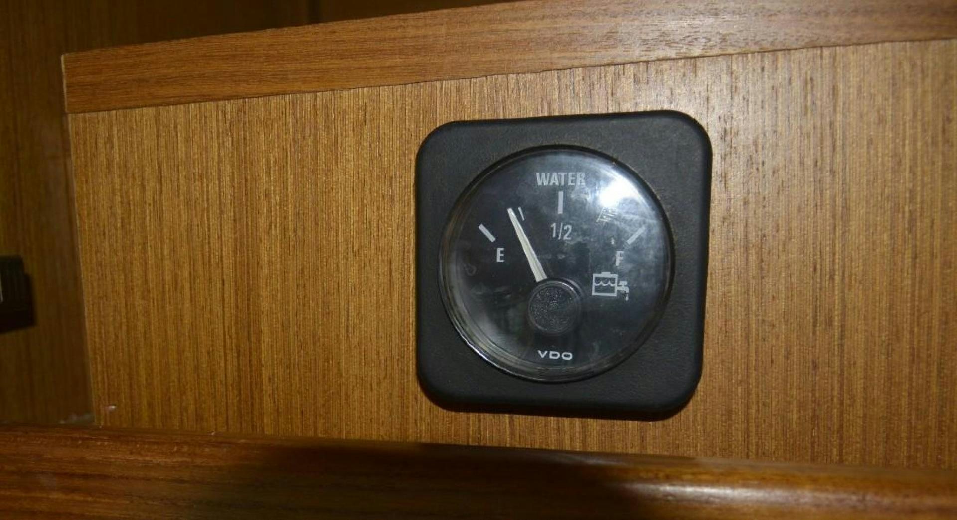 a black watch on a wooden surface aboard DOG HOUSE Yacht for Sale