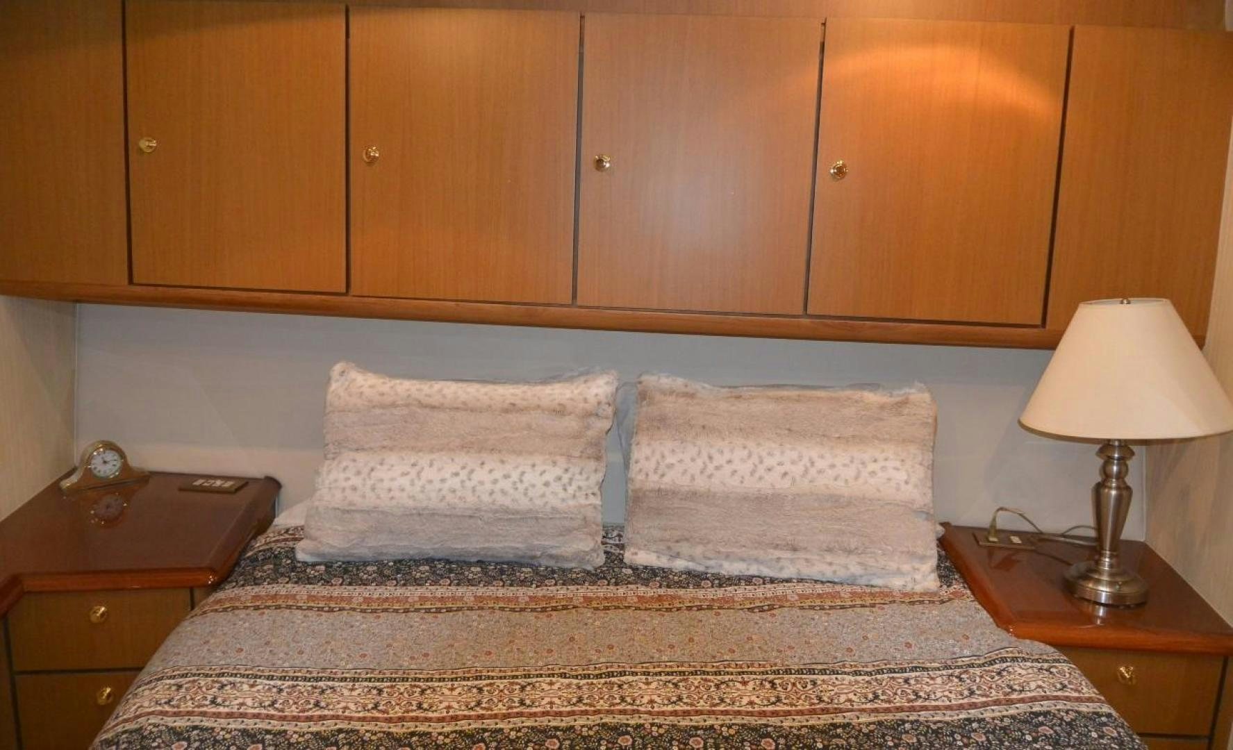 a bed with a lamp on it aboard DOG HOUSE Yacht for Sale
