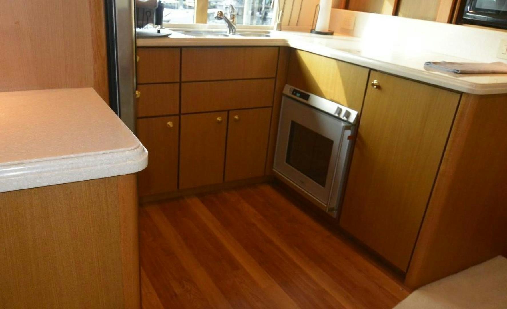 a kitchen with wooden cabinets aboard DOG HOUSE Yacht for Sale