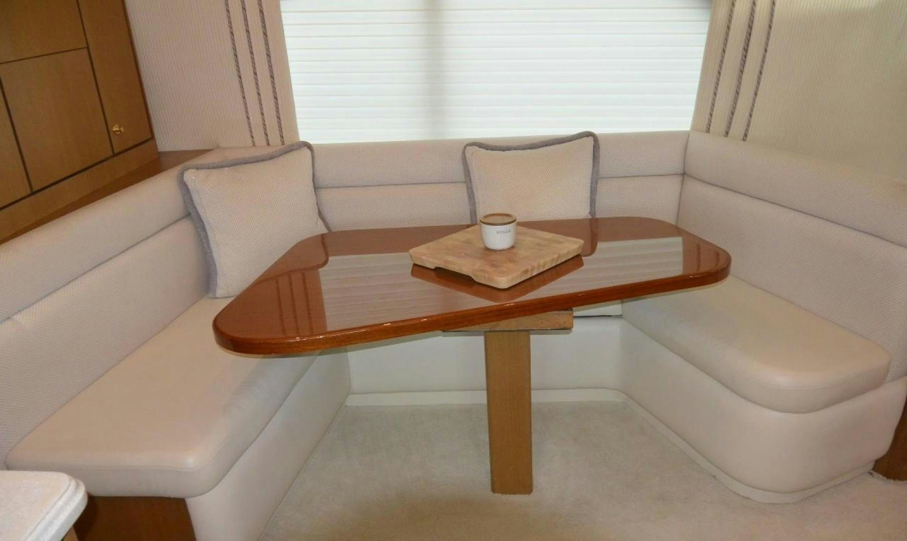 a coffee table with a chair aboard DOG HOUSE Yacht for Sale