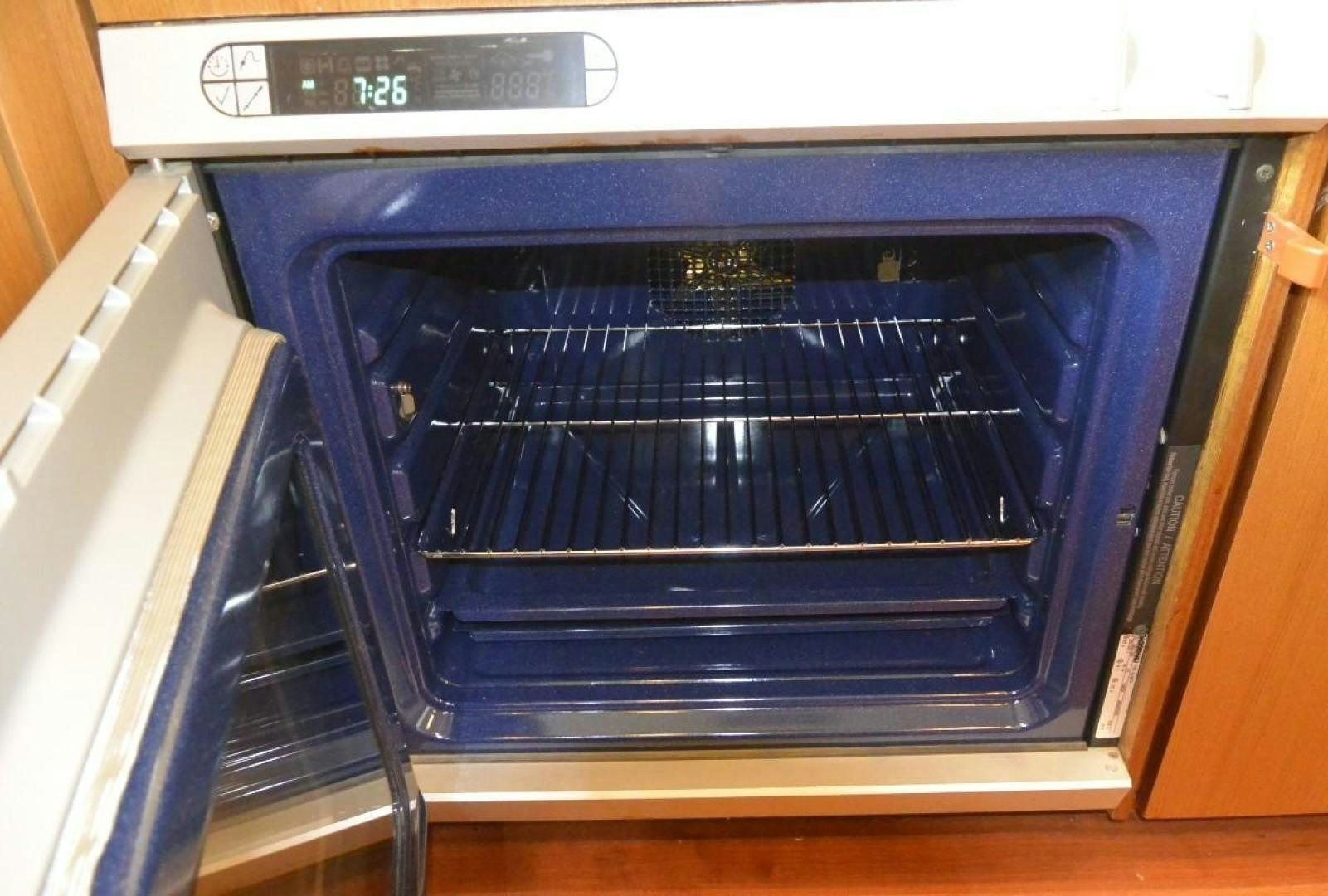 an open oven with a door open aboard DOG HOUSE Yacht for Sale