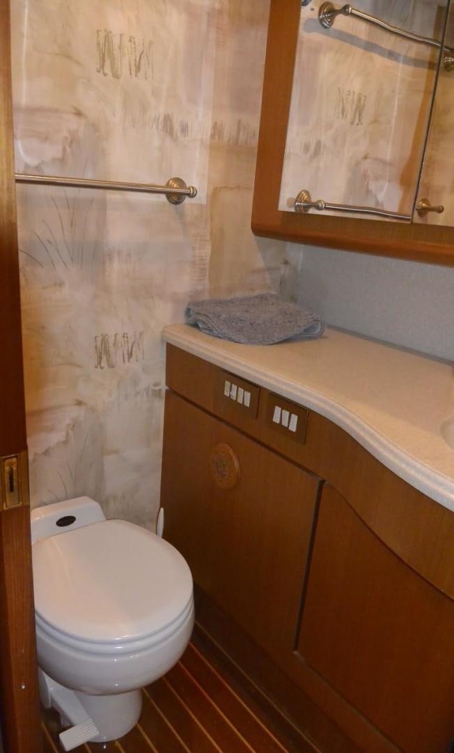 a bathroom with a toilet and a sink aboard DOG HOUSE Yacht for Sale