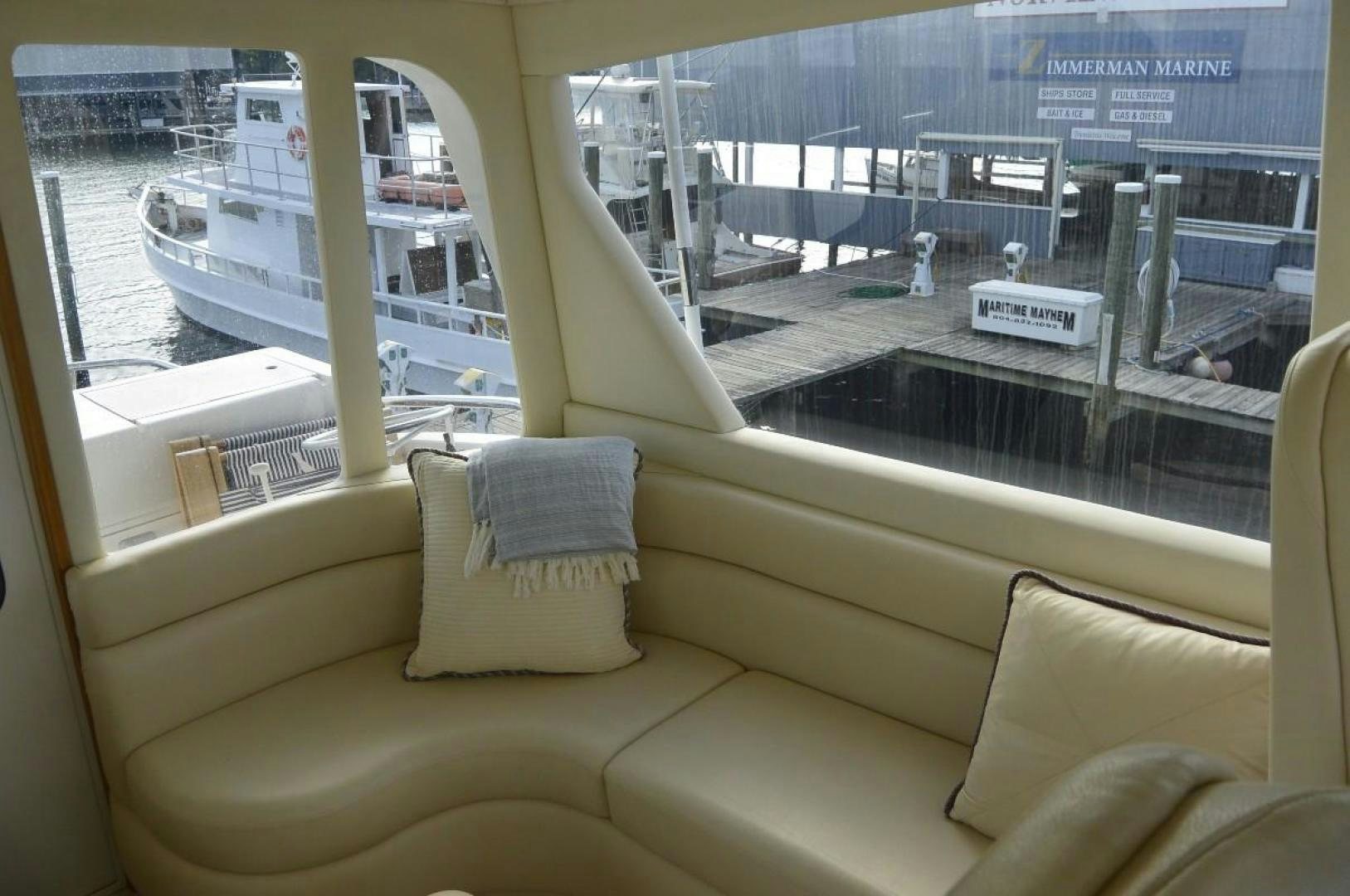 a couch and a window overlooking a city aboard DOG HOUSE Yacht for Sale
