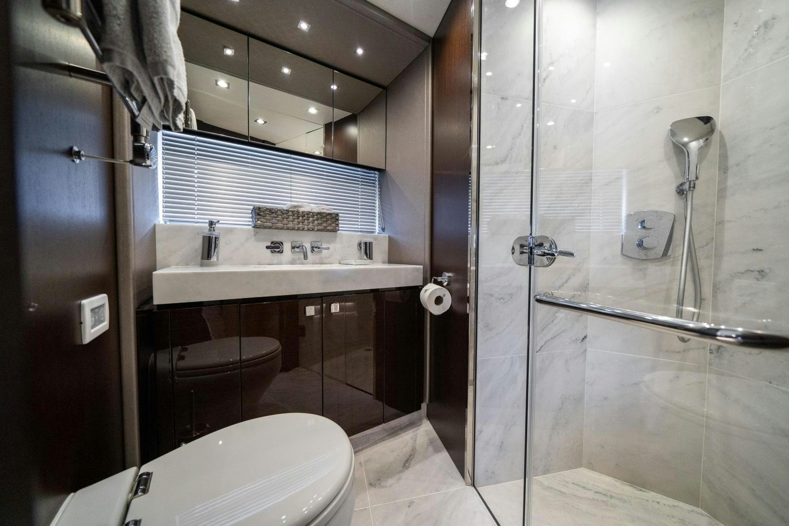 a bathroom with a glass shower aboard Life for Sale Yacht for Sale