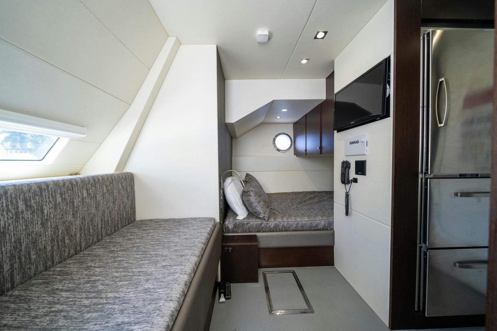 a kitchen with a couch and a refrigerator aboard Life for Sale Yacht for Sale