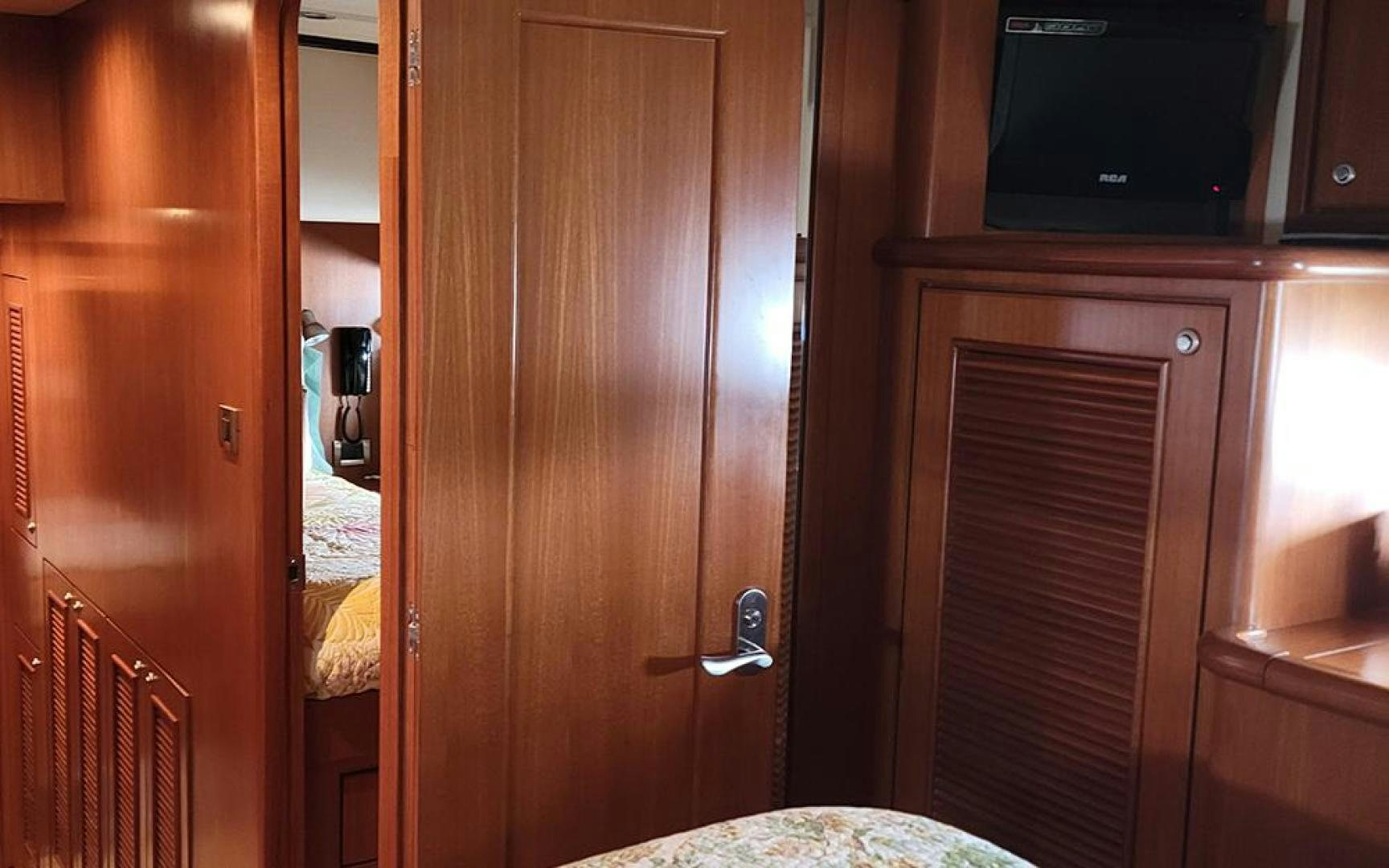 a wooden closet with a television on the wall aboard GOWIN PLACES IV Yacht for Sale