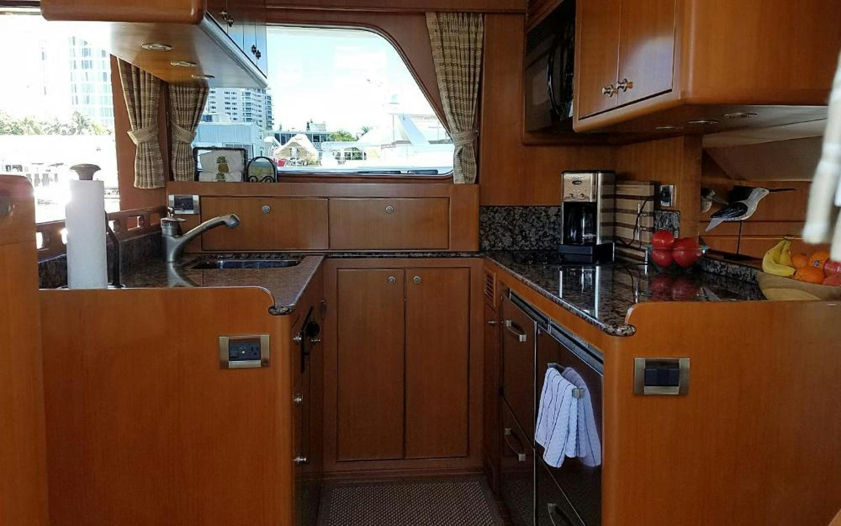 a kitchen with wooden cabinets aboard GOWIN PLACES IV Yacht for Sale