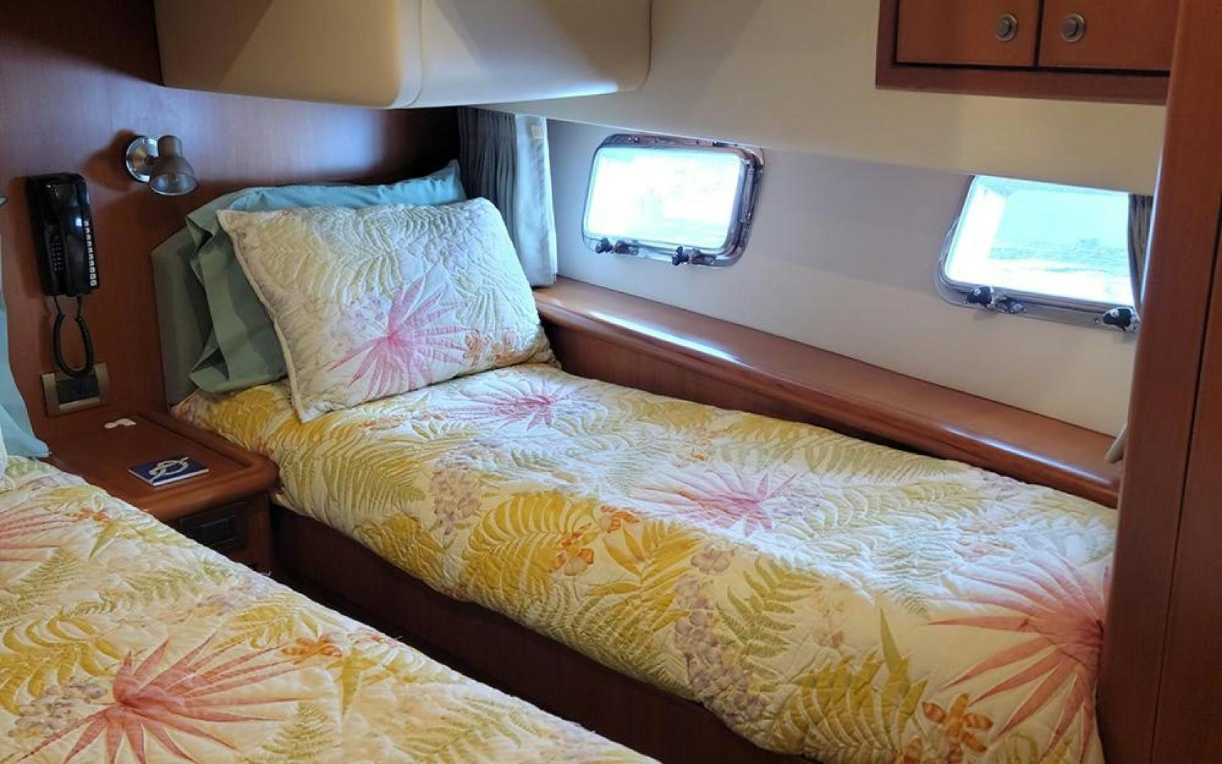 a bed with a television on the wall aboard GOWIN PLACES IV Yacht for Sale