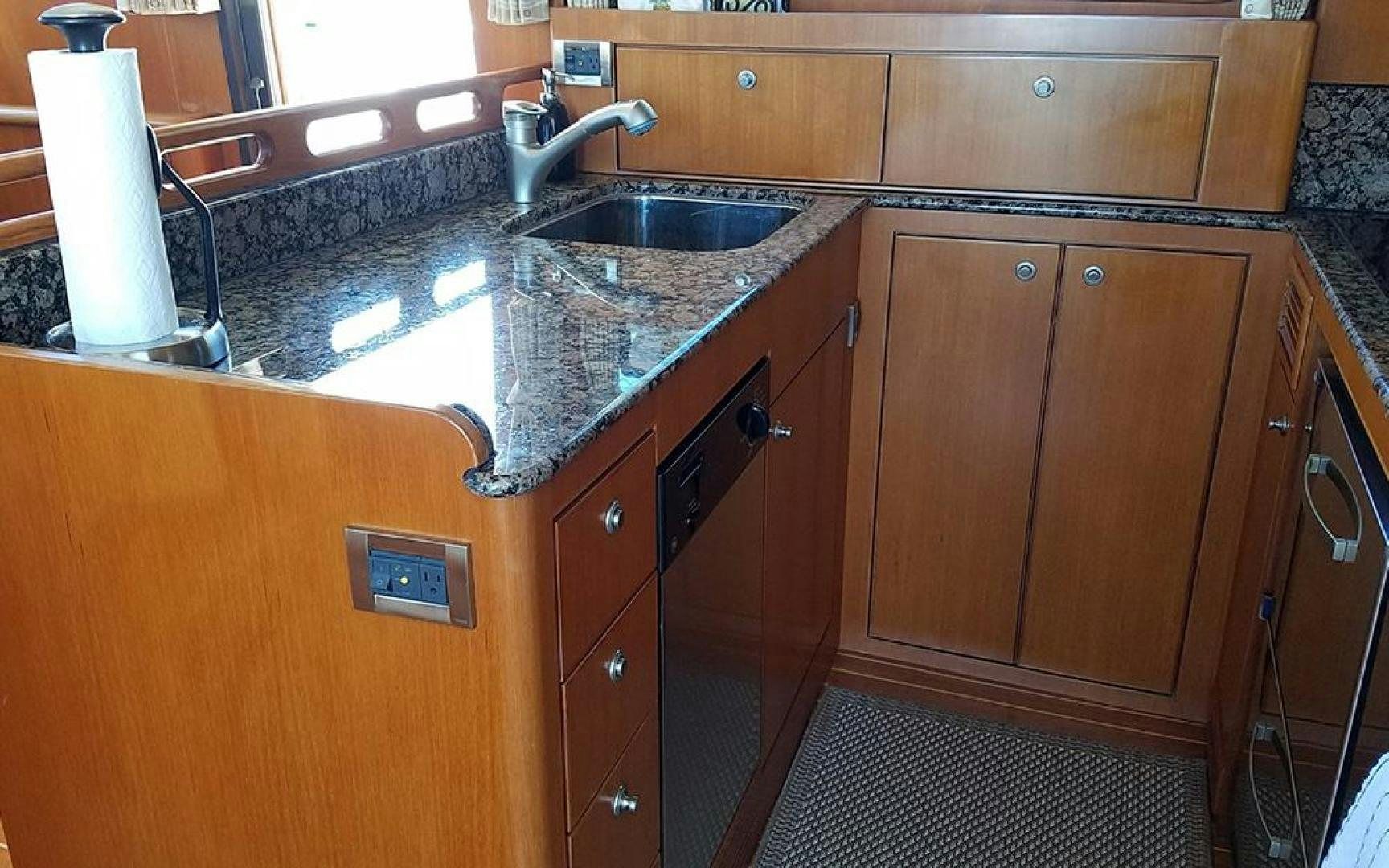 a kitchen with a marble counter top aboard GOWIN PLACES IV Yacht for Sale