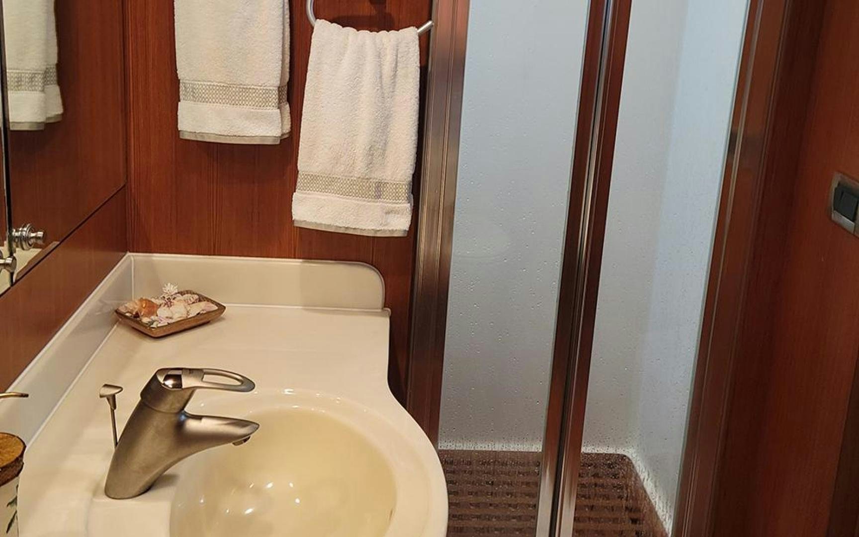 a bathroom with a sink and towels aboard GOWIN PLACES IV Yacht for Sale