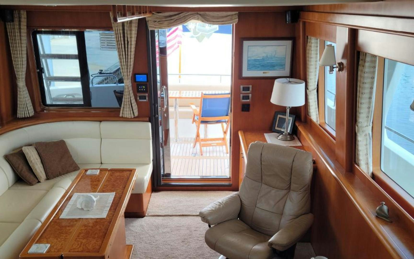 a room with a couch and a table and a window aboard GOWIN PLACES IV Yacht for Sale