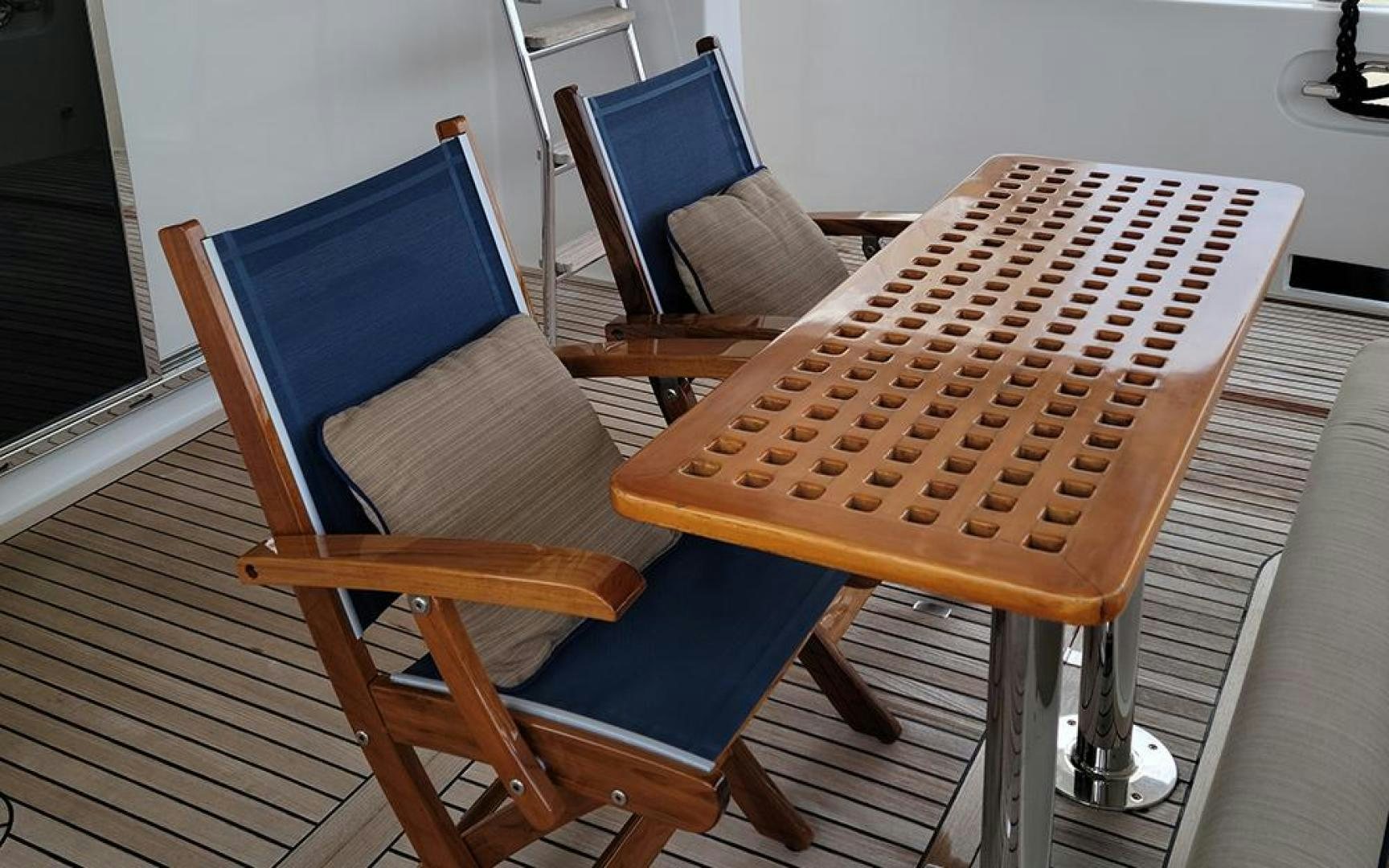 a couple of chairs with an umbrella on top of them aboard GOWIN PLACES IV Yacht for Sale