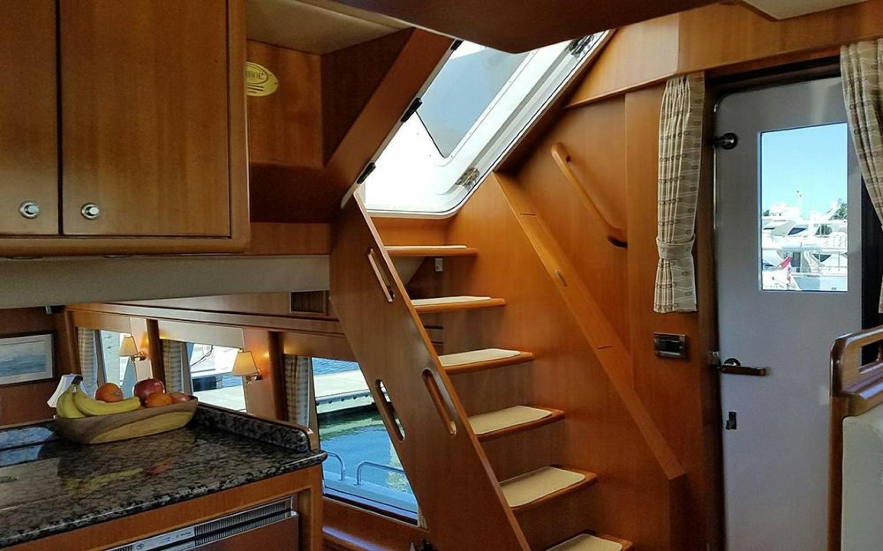 a kitchen with wooden cabinets aboard GOWIN PLACES IV Yacht for Sale