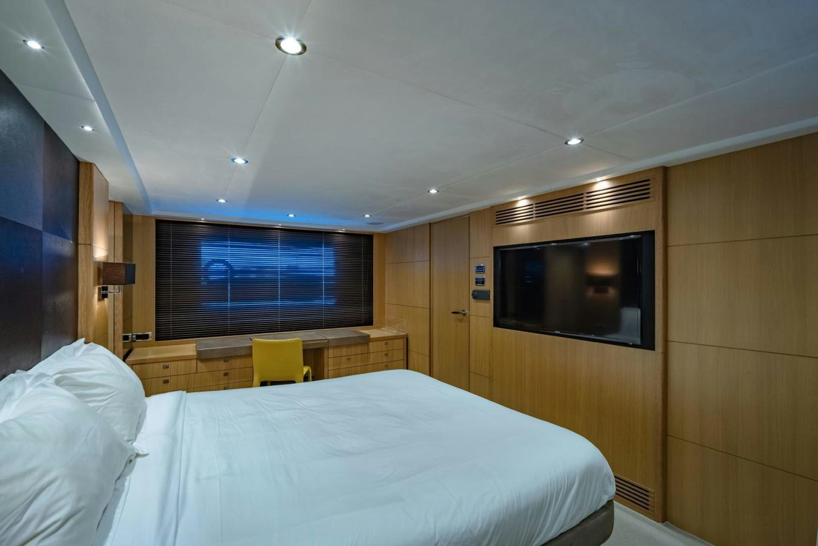 a room with a bed and a television aboard GIFZY Yacht for Sale
