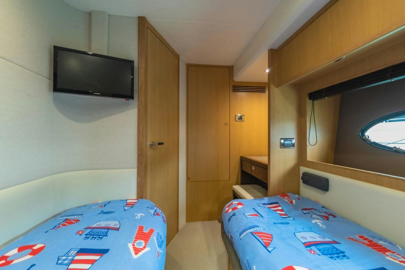 a bedroom with a tv and a bed aboard GIFZY Yacht for Sale