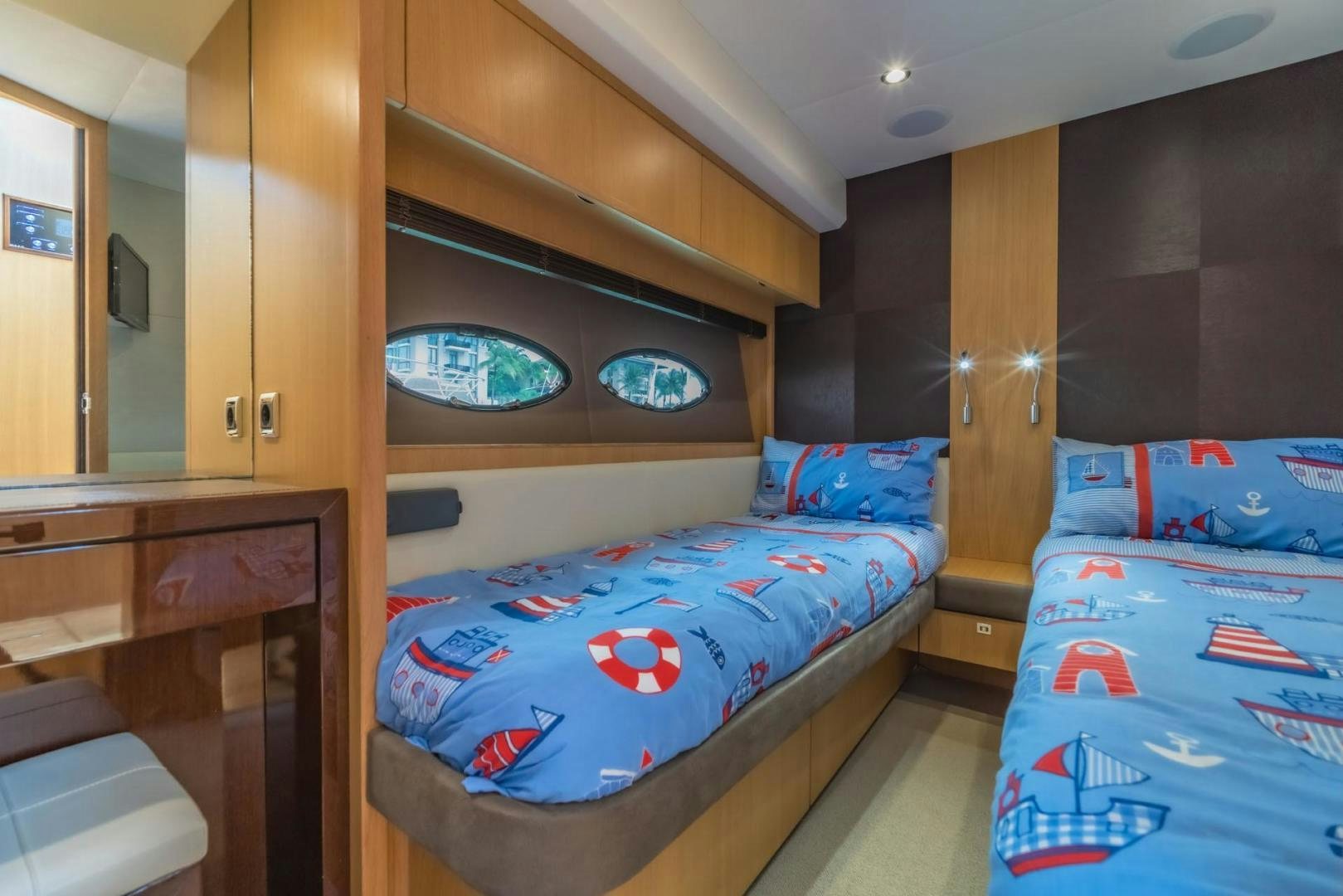 a room with a bed and a dresser aboard GIFZY Yacht for Sale