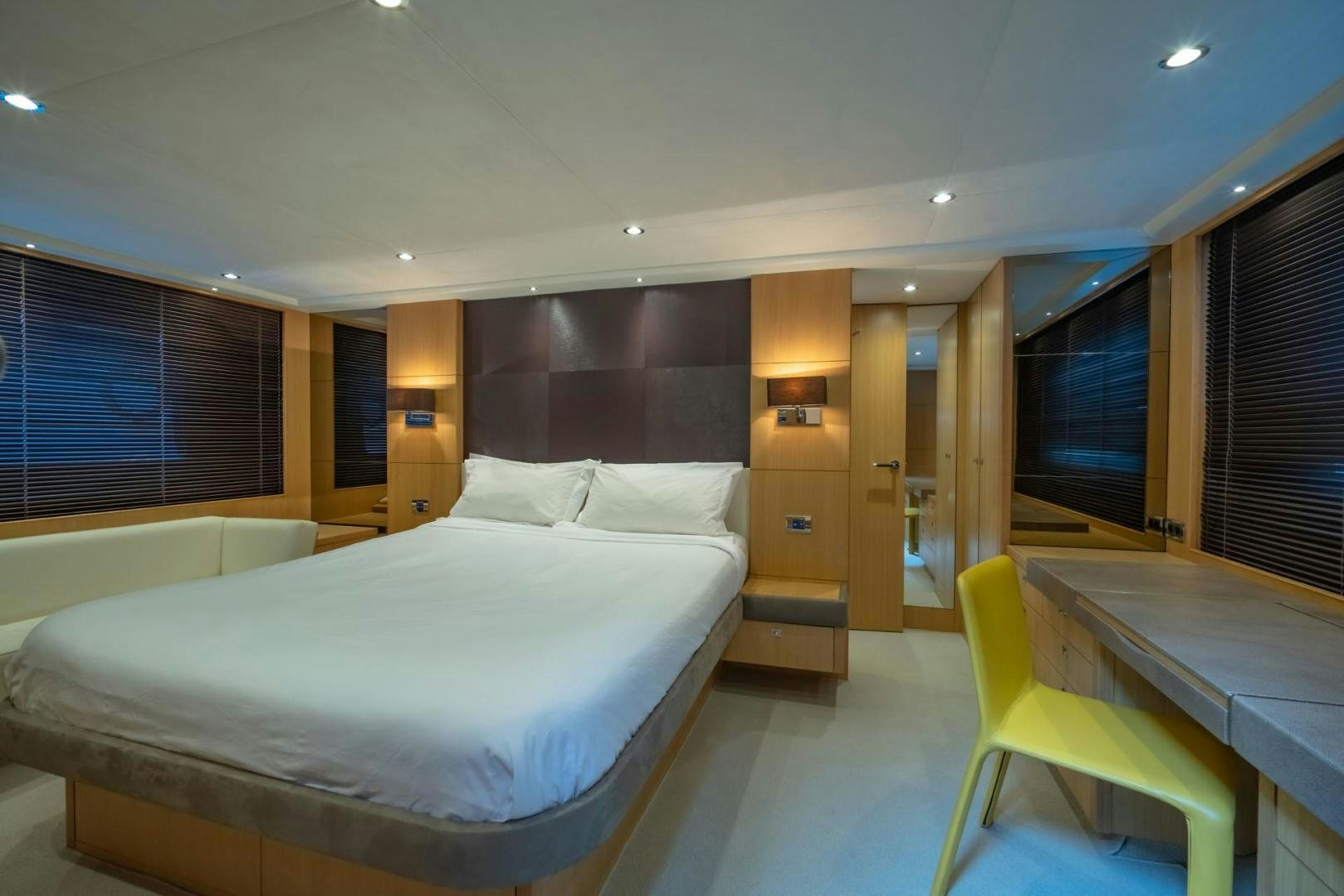 a room with a bed and a chair aboard GIFZY Yacht for Sale