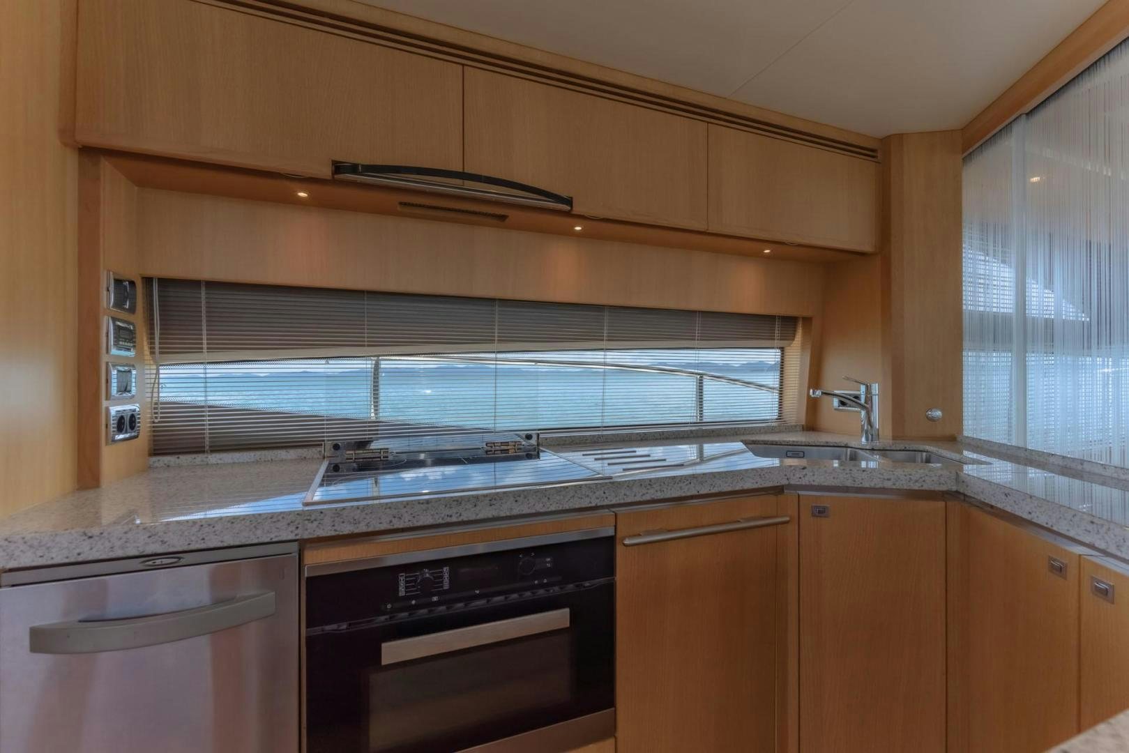 a kitchen with wooden cabinets aboard GIFZY Yacht for Sale