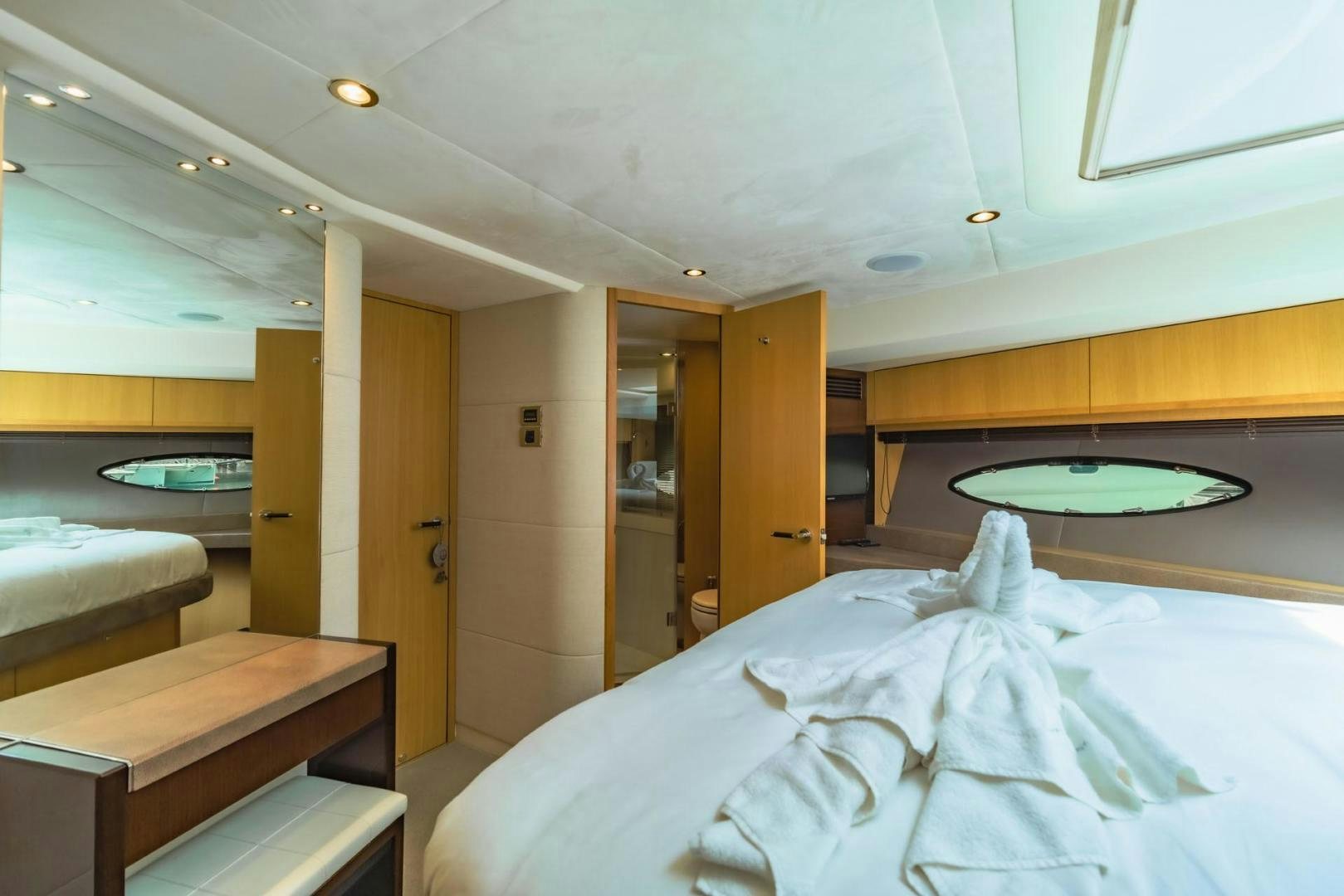 a room with a bed and a table aboard GIFZY Yacht for Sale