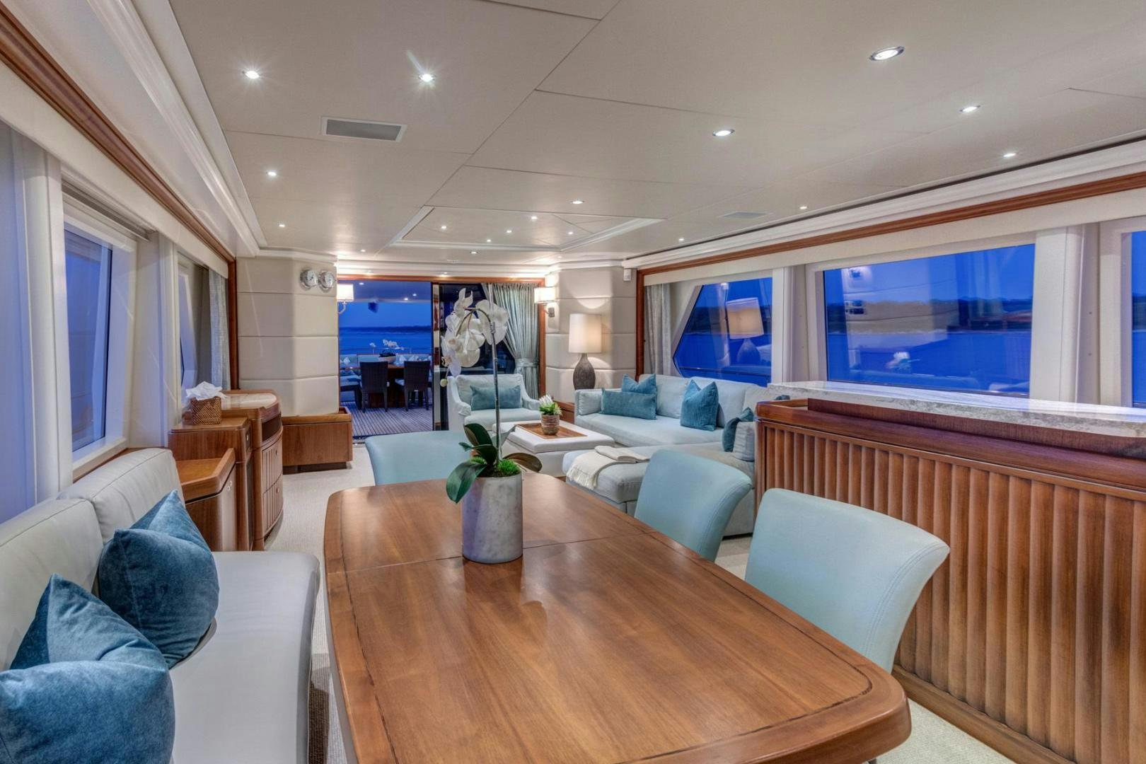 a living room with a table and chairs aboard PURA VIDA Yacht for Sale