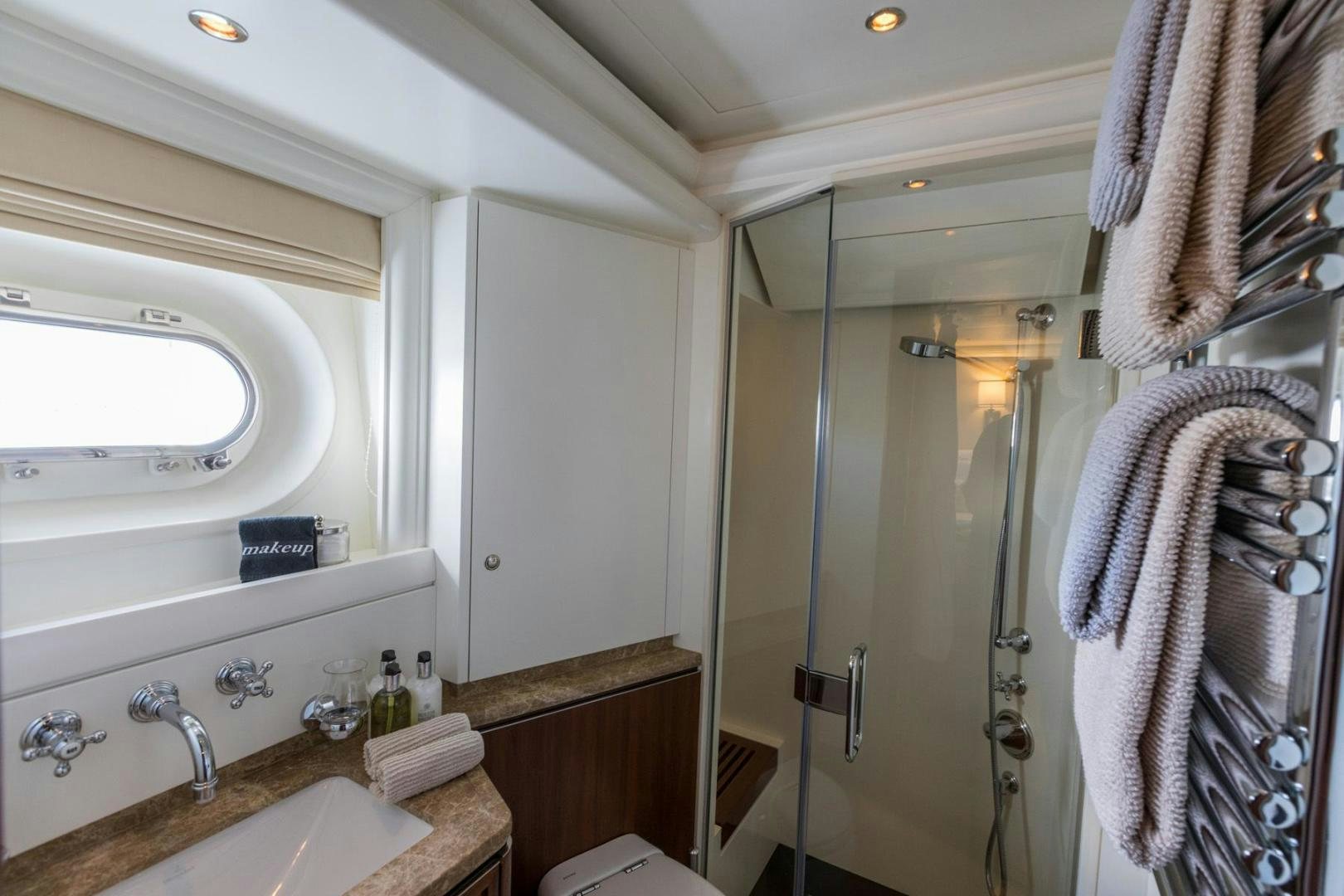 a bathroom with a shower and sink aboard PURA VIDA Yacht for Sale