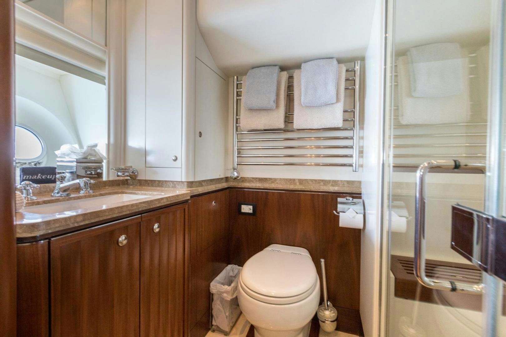 a bathroom with a toilet and sink aboard PURA VIDA Yacht for Sale