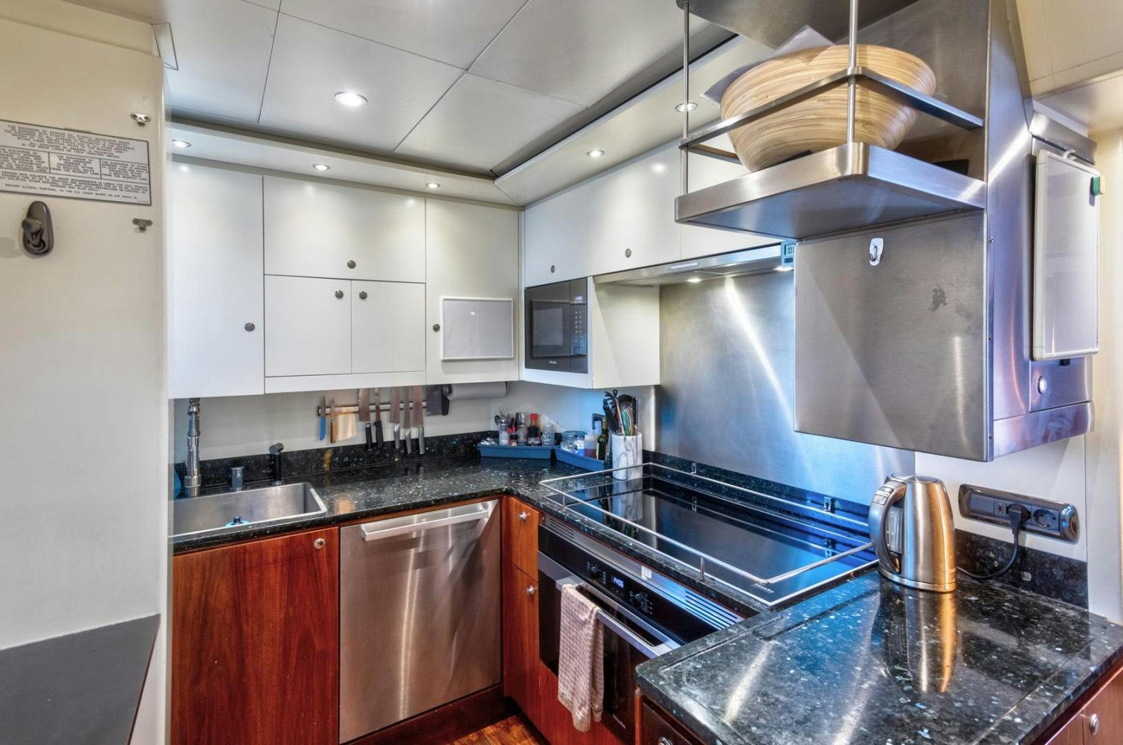 a kitchen with a stainless steel stove aboard PURA VIDA Yacht for Sale