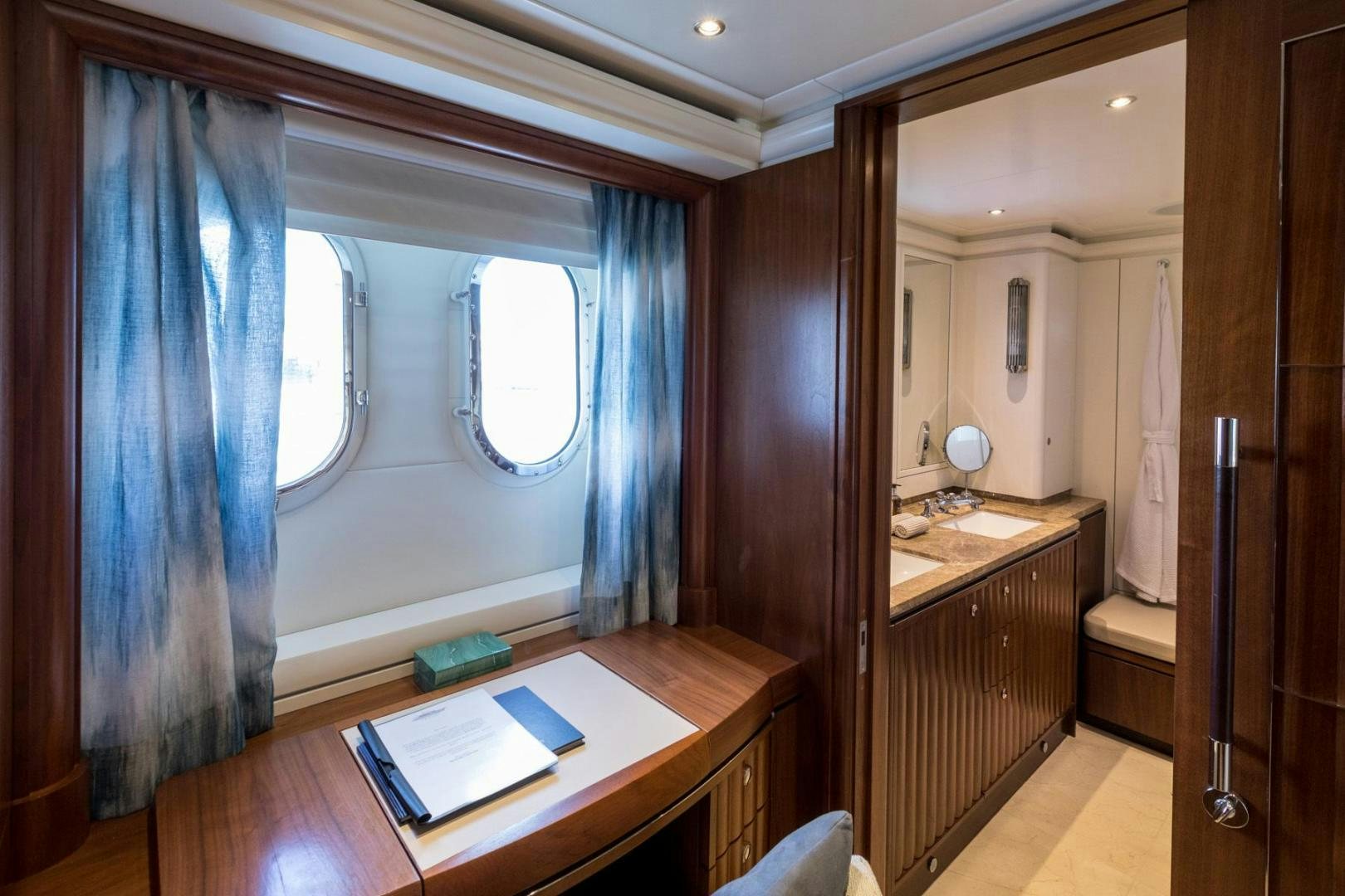 a bathroom with a countertop sink and a window aboard PURA VIDA Yacht for Sale