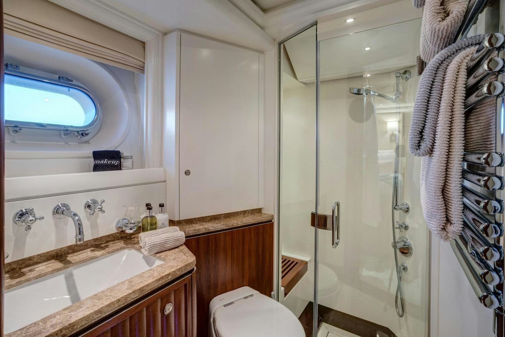 a bathroom with a shower and sink aboard PURA VIDA Yacht for Sale
