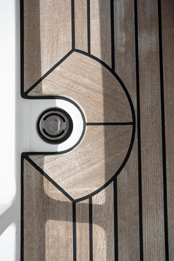 a black and white photo of a black and white spiral staircase aboard PURA VIDA Yacht for Sale