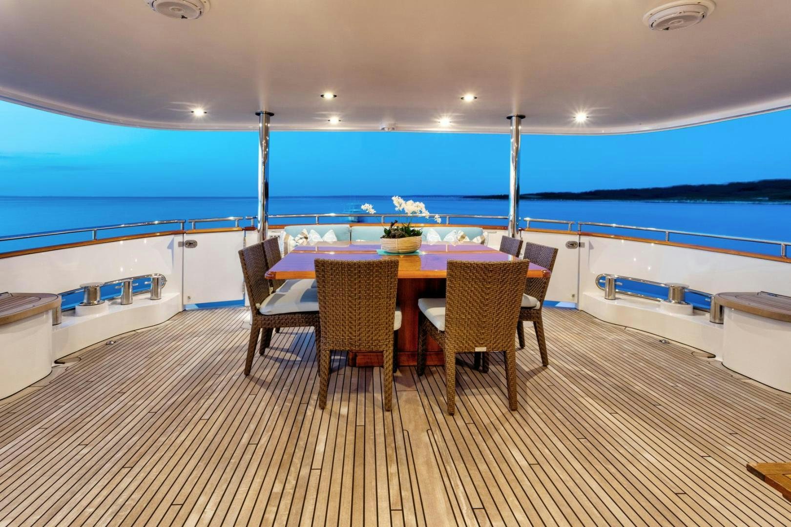 a table and chairs on a deck aboard PURA VIDA Yacht for Sale