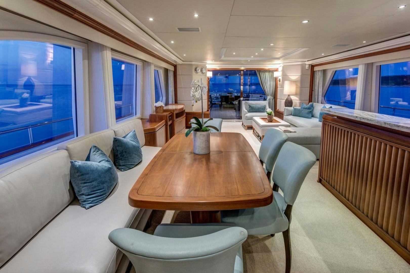 a living room with a table and chairs aboard PURA VIDA Yacht for Sale