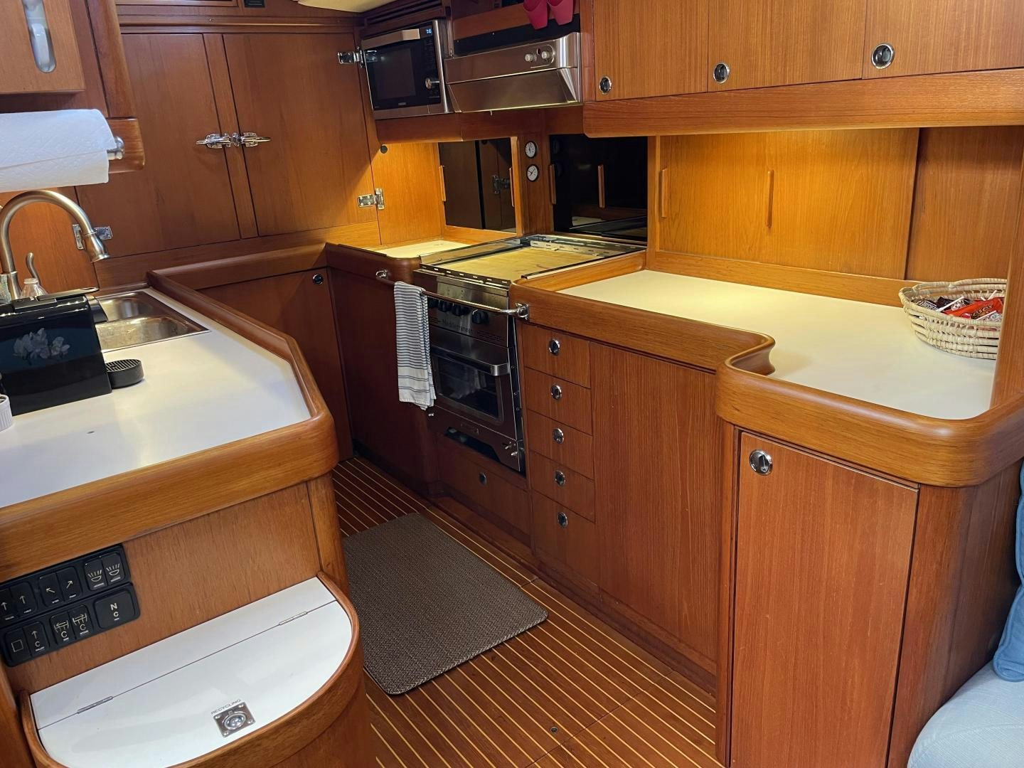 a kitchen with wooden cabinets aboard DISCO LEMONADE Yacht for Sale