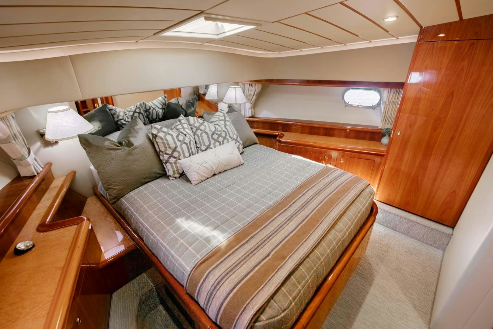 a bed with a blue comforter aboard LIVING LIFE Yacht for Sale