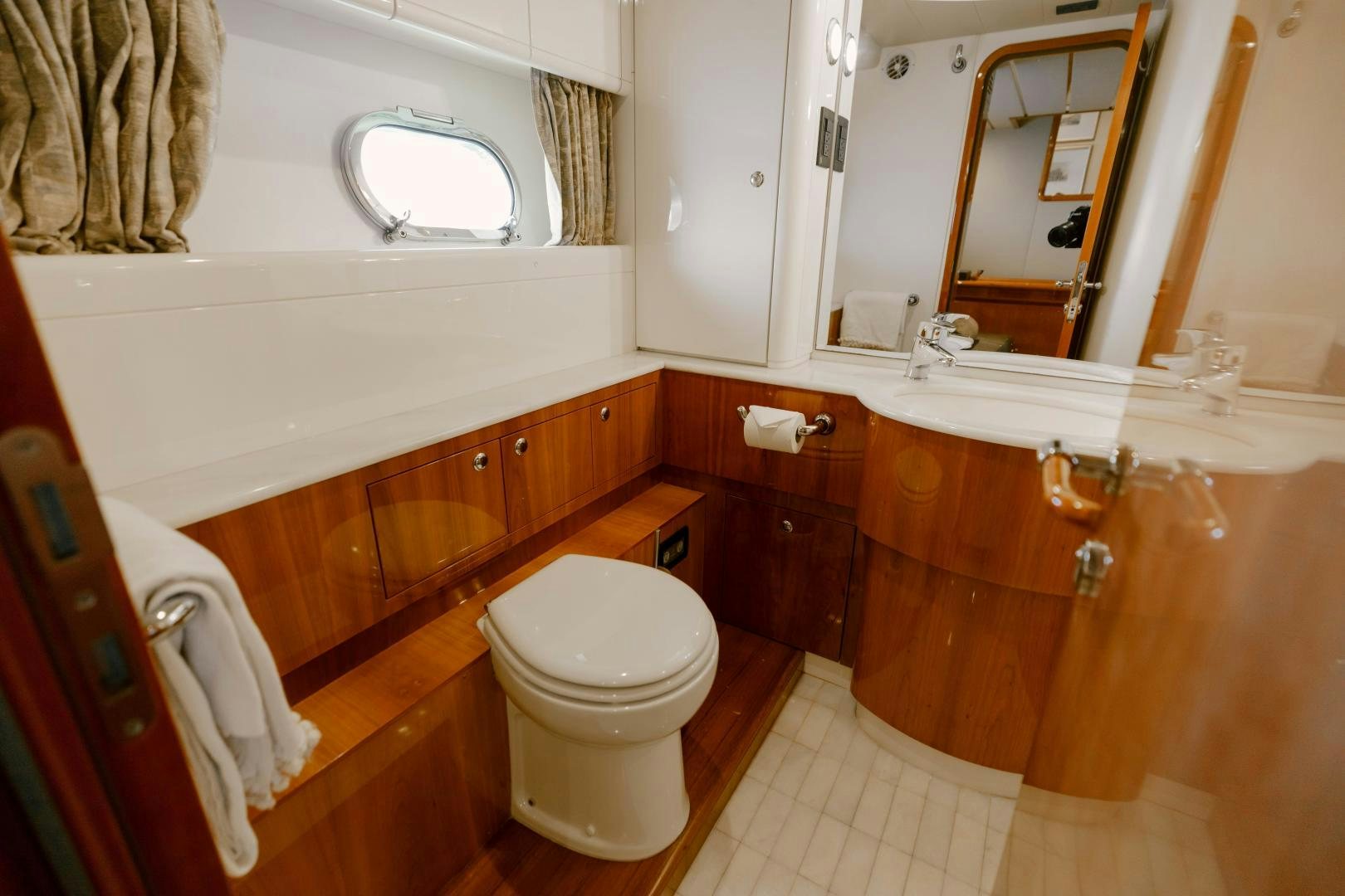 a bathroom with a toilet and a mirror aboard LIVING LIFE Yacht for Sale