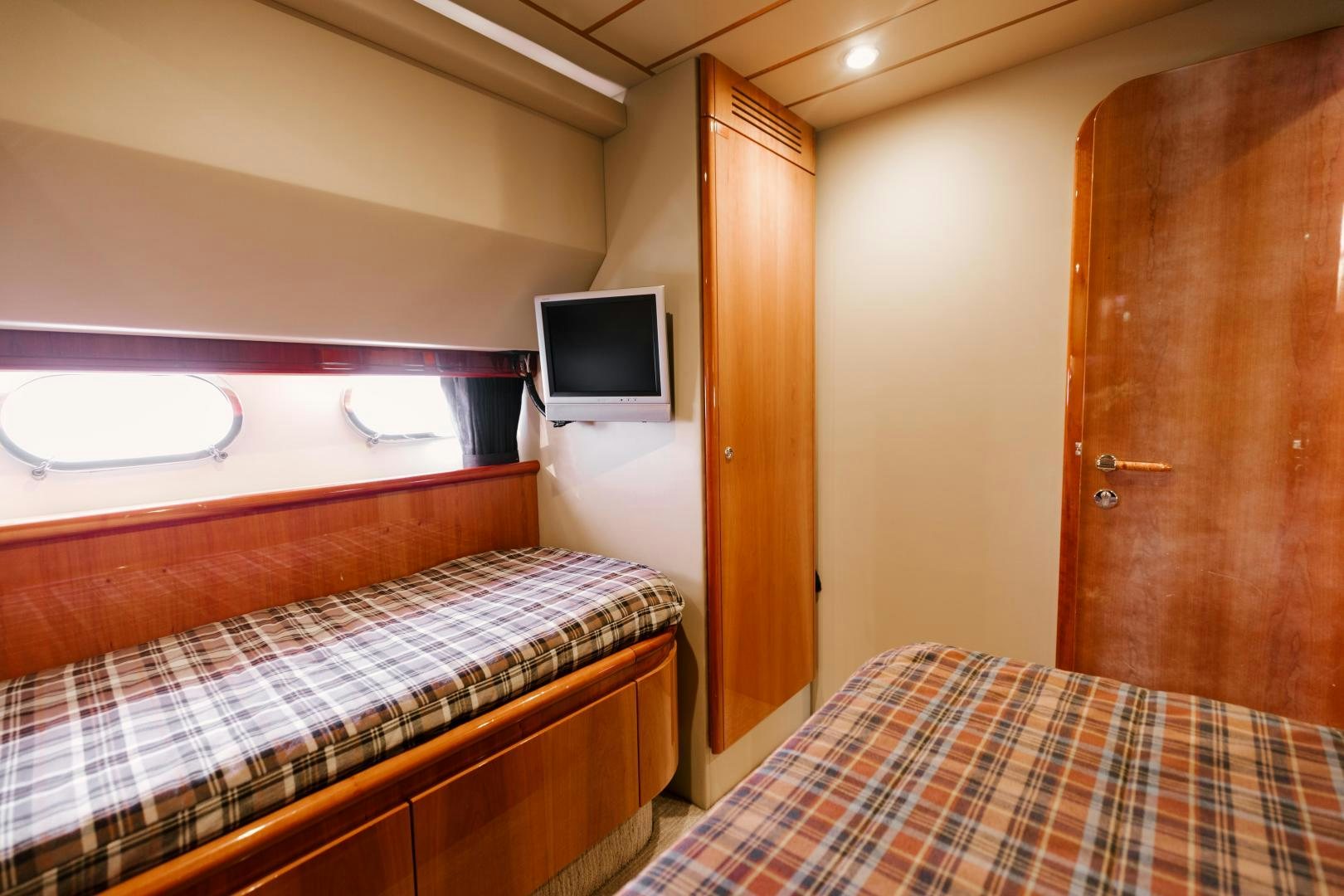 a bedroom with a bed and a television aboard LIVING LIFE Yacht for Sale