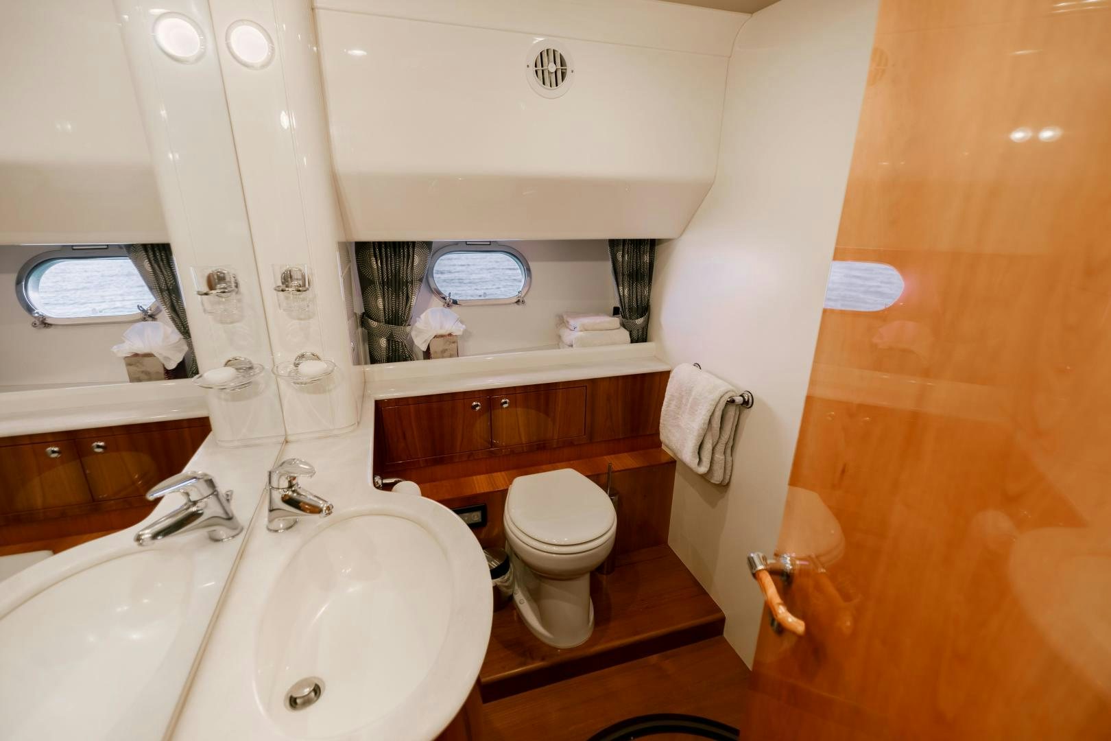 a bathroom with a toilet sink and a mirror aboard LIVING LIFE Yacht for Sale