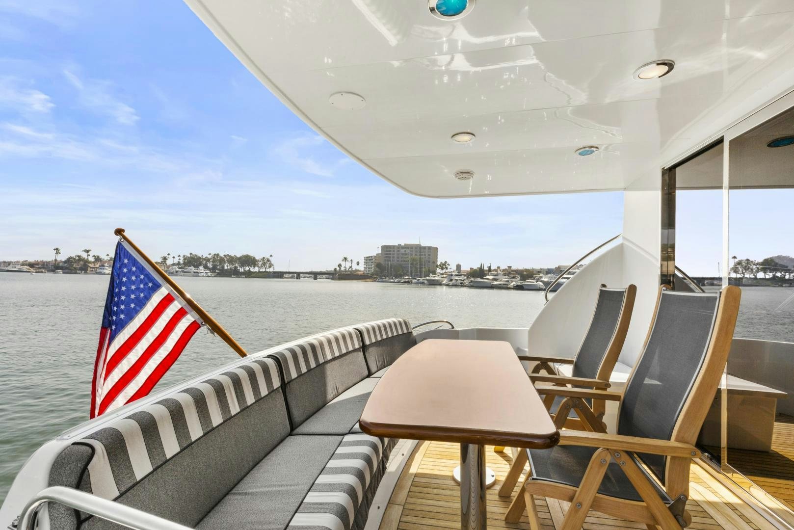 a boat with a flag on the deck aboard RILASSARI Yacht for Sale