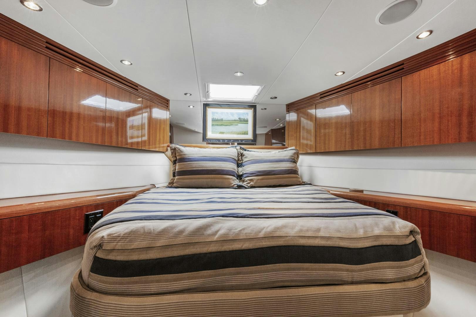 a room with a bed and a wood wall aboard RILASSARI Yacht for Sale