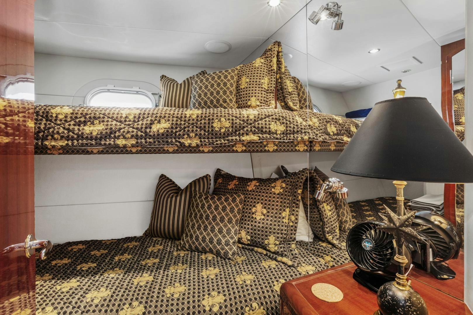 a bed with a gold headboard aboard RILASSARI Yacht for Sale