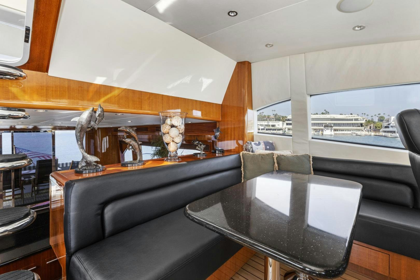a room with a large window and a statue on the table aboard RILASSARI Yacht for Sale