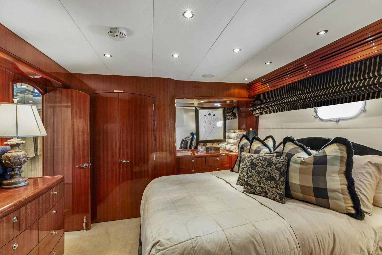 a bedroom with a bed and a wood wall aboard RILASSARI Yacht for Sale