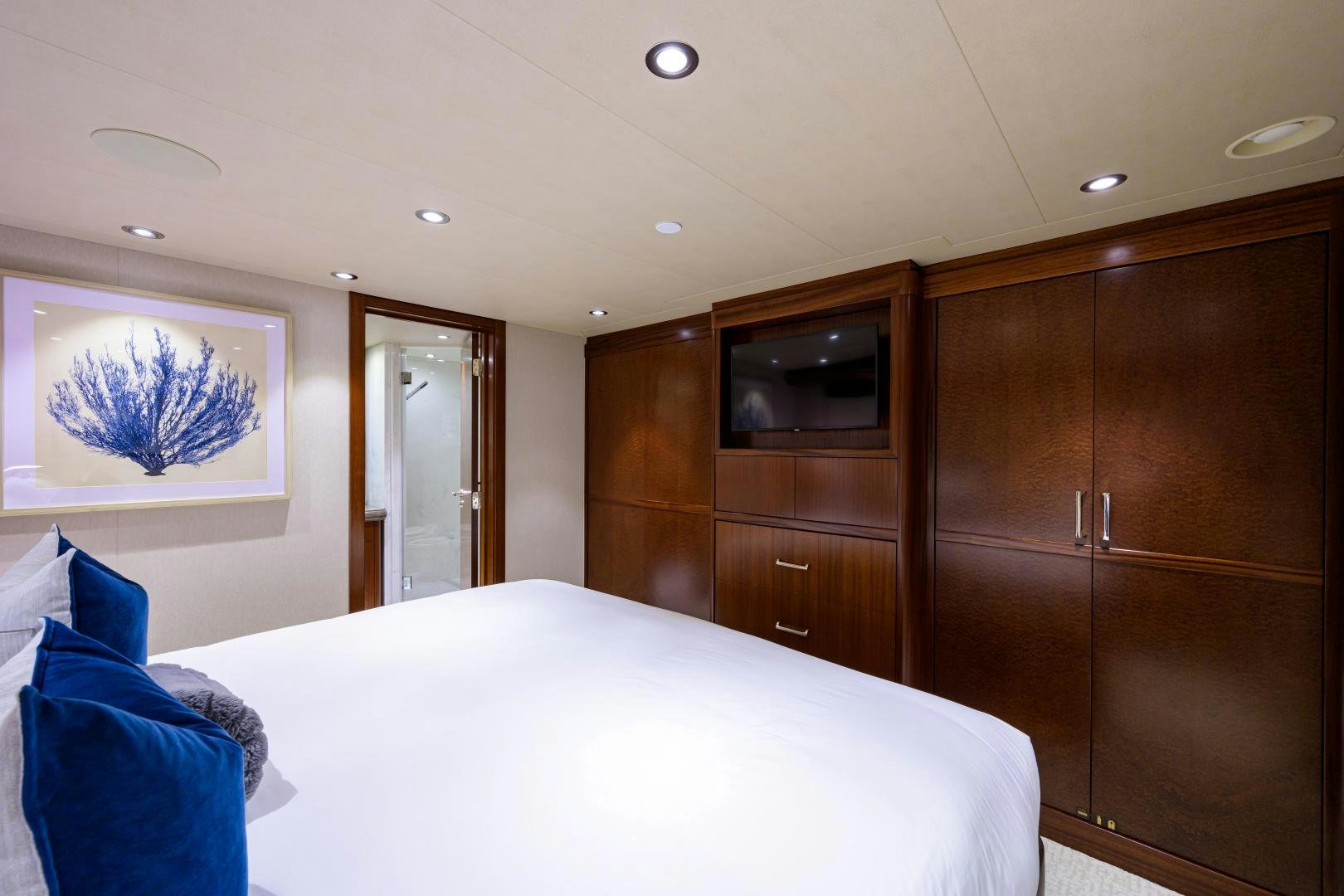 a bedroom with a bed and cabinets aboard LADY JJ Yacht for Sale