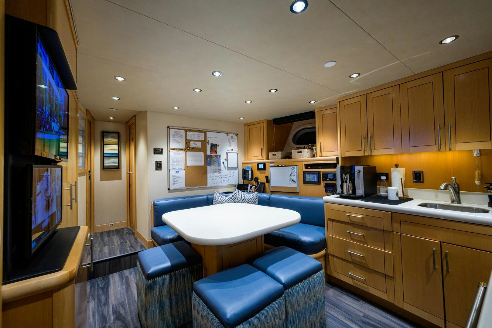 a kitchen with a tv and a table aboard LADY JJ Yacht for Sale