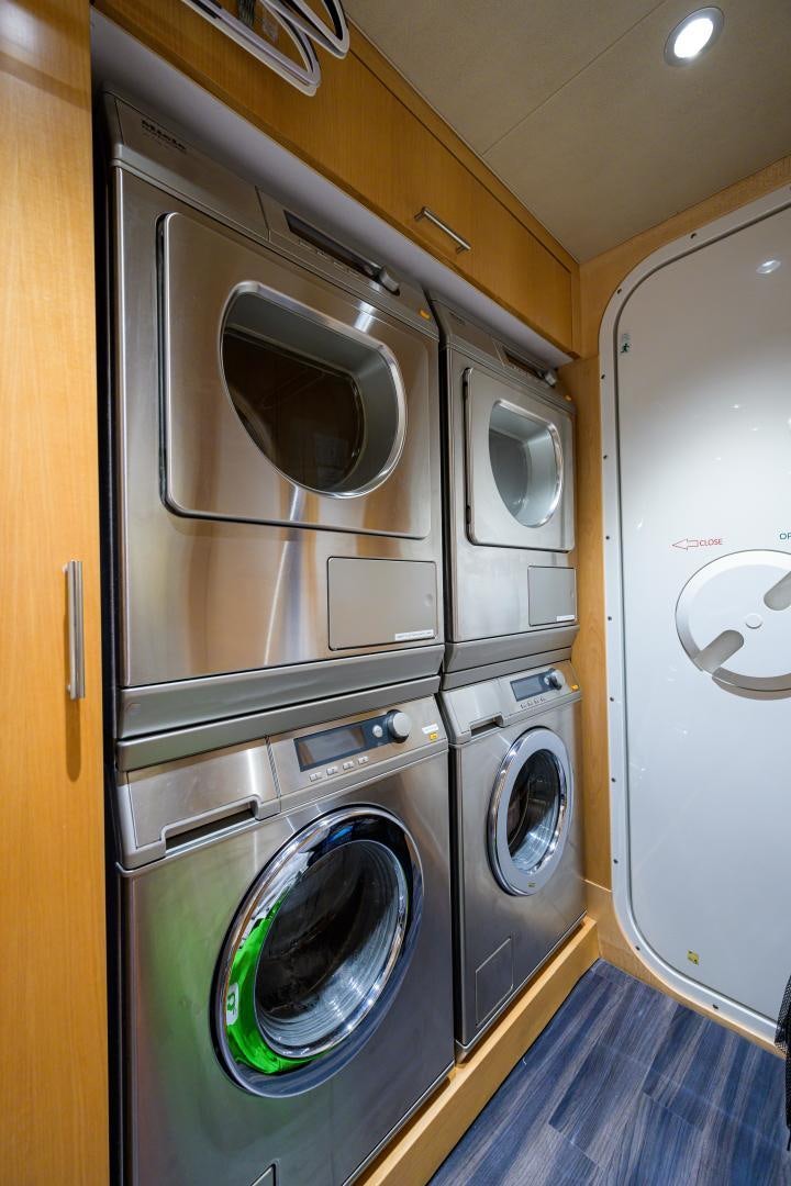 a room with washer and dryer aboard LADY JJ Yacht for Sale