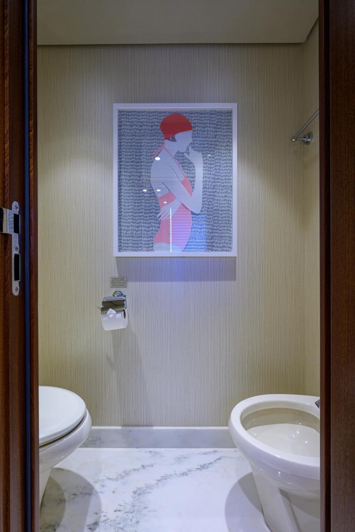a bathroom with a picture on the wall aboard LADY JJ Yacht for Sale