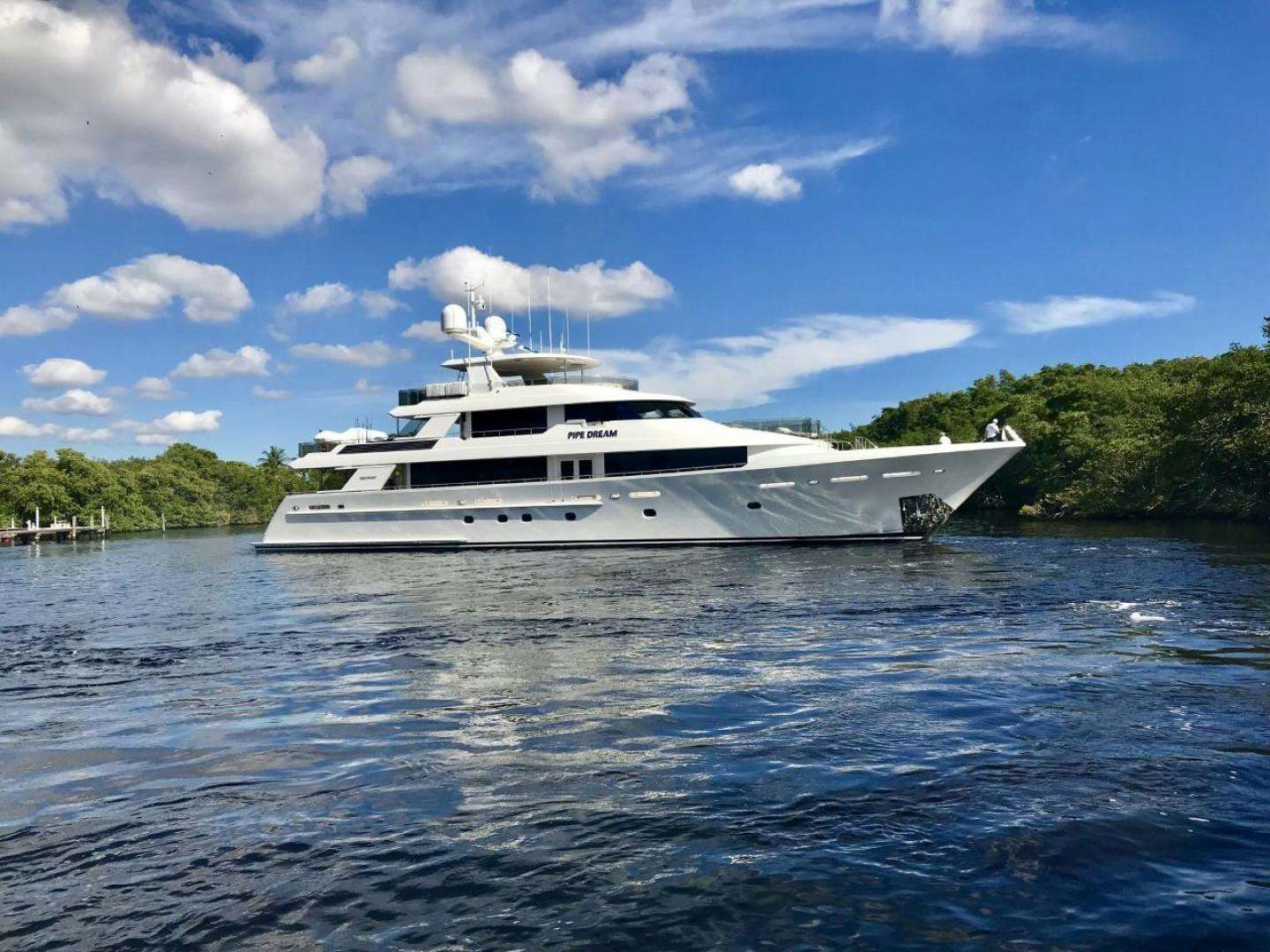 a white yacht in the water aboard PIPE DREAM Yacht for Sale